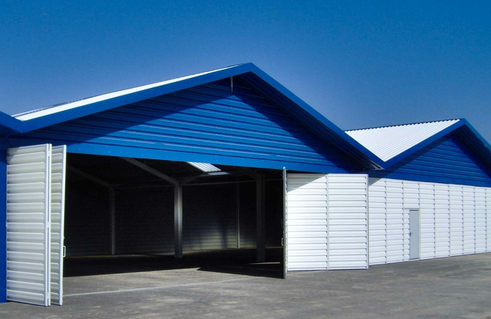 Biało niebieska hala z dachem z płyty trapezowej